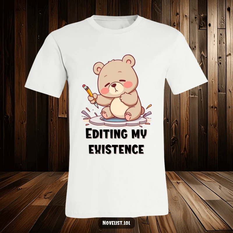 Funny t-shirt showing a clumsy bear comically trying to swat away a plot hole with a pen, capturing writer's block struggles.
